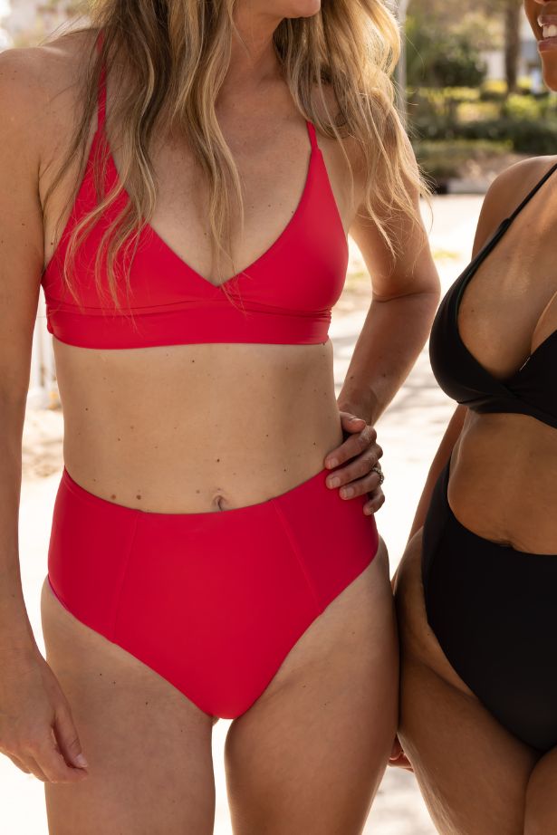 Red triangle wrap bikini top with deep V front and supportive band paired with high waist bottoms, active women’s swimwear